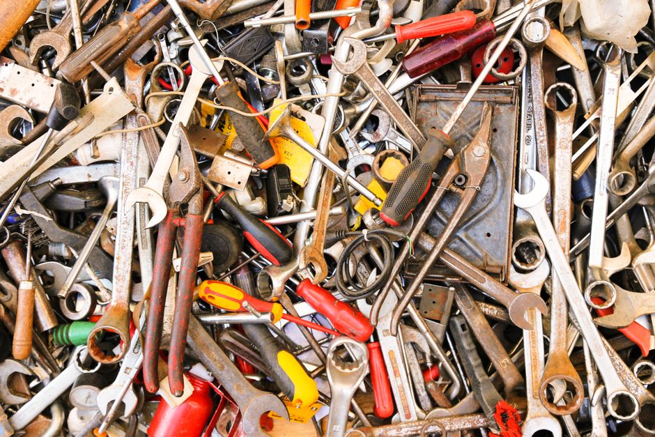 A vibrant assortment of various hand tools arranged in a pile. Ideal for construction themes.