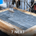 Close-up of an automated machine processing metal parts in an industrial setting.