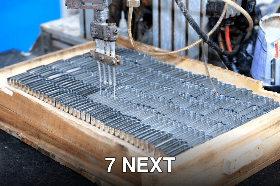 Close-up of an automated machine processing metal parts in an industrial setting.