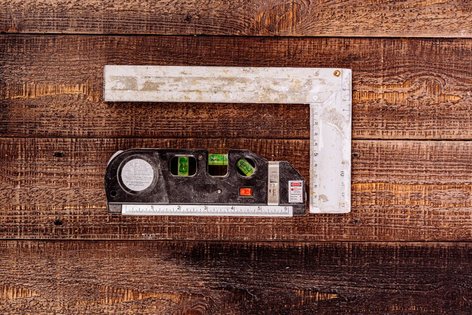 Top view of carpenter's measuring tools on rustic wooden surface, ideal for construction concepts.