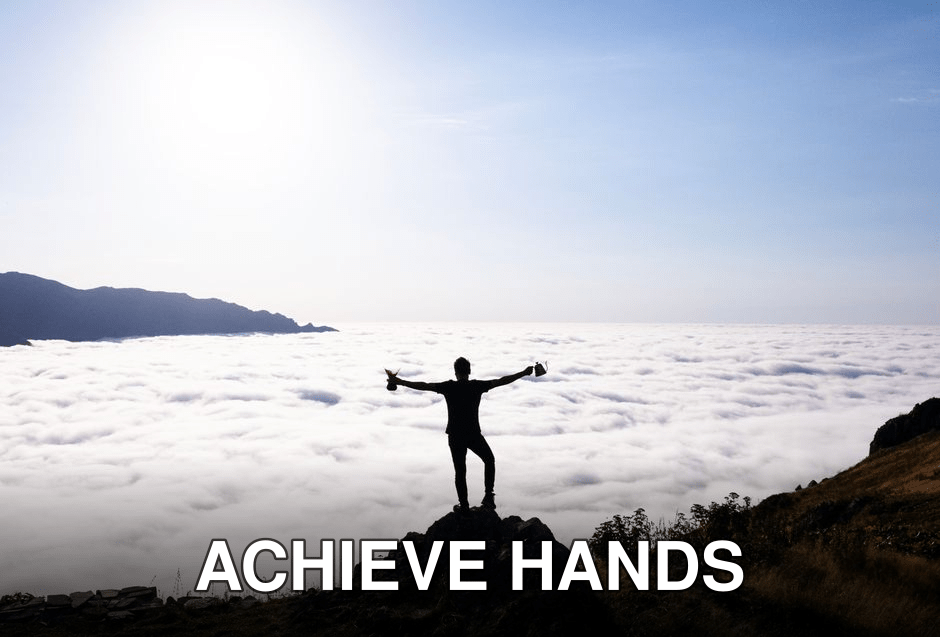 Silhouette of a man raising arms on a rocky hilltop above clouds in Artvin, Türkiye