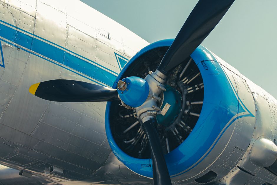 Detailed view of a vintage aircraft propeller engine with blue accents in Budapest.