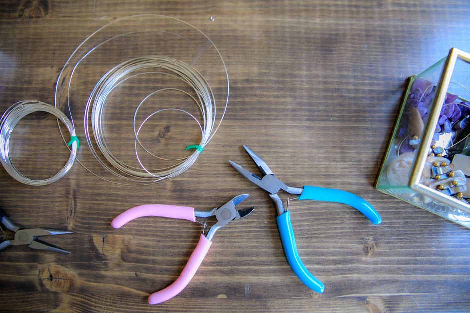 Crafting tools and wires on wood surface, ideal for DIY projects and hobbyists.