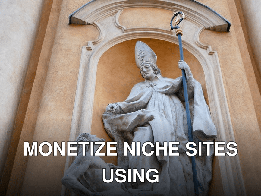 A detailed stone statue representing a religious figure on a historic building facade.