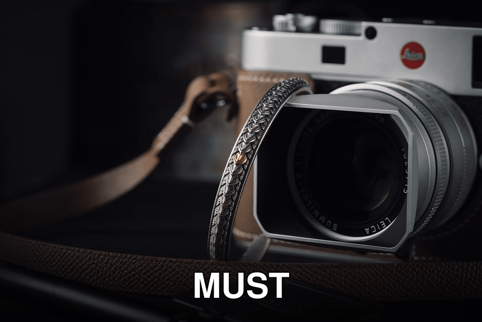Elegant camera setup with handmade strap and lens cap, perfect for photography enthusiasts.