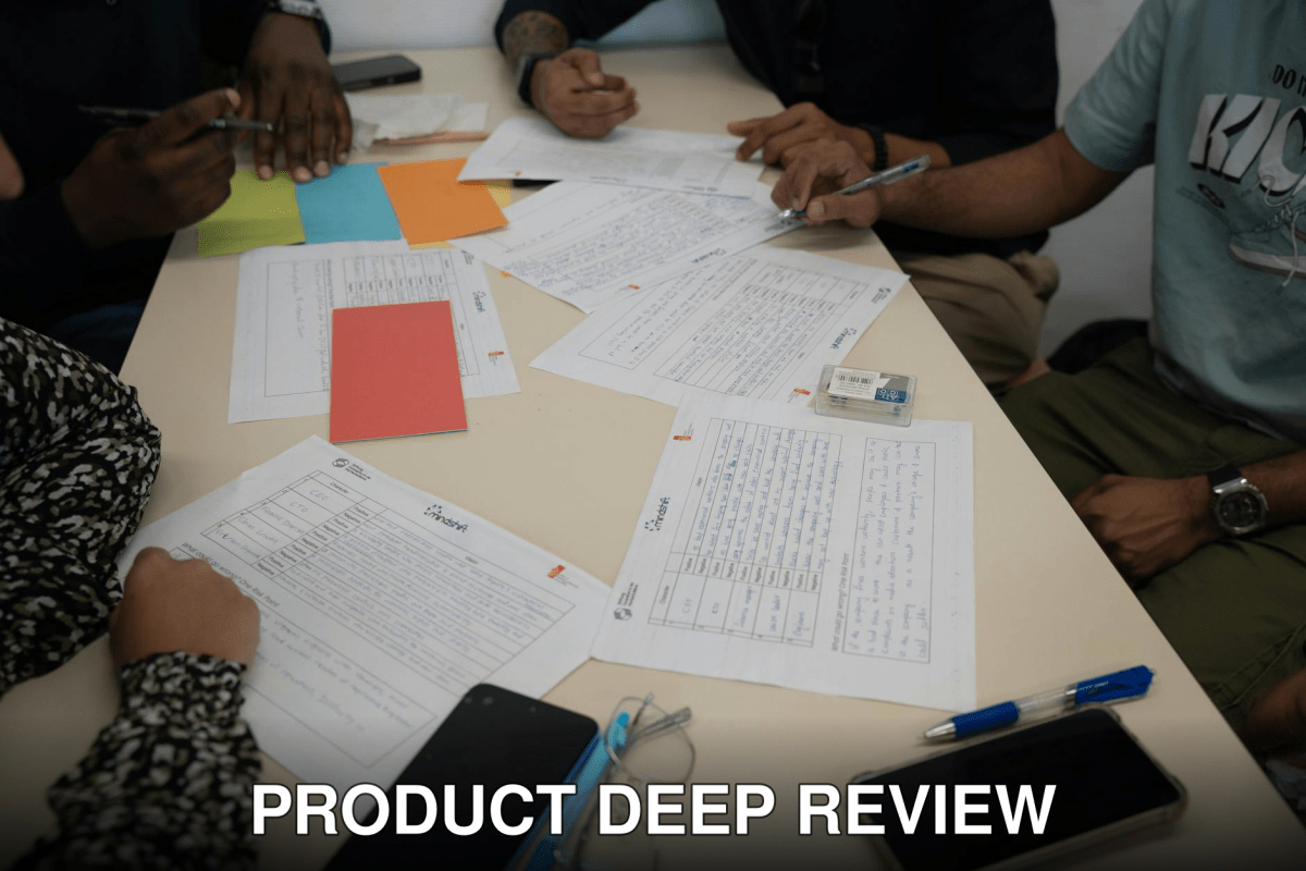 A diverse team working together, reviewing documents and making notes during a collaborative meeting.