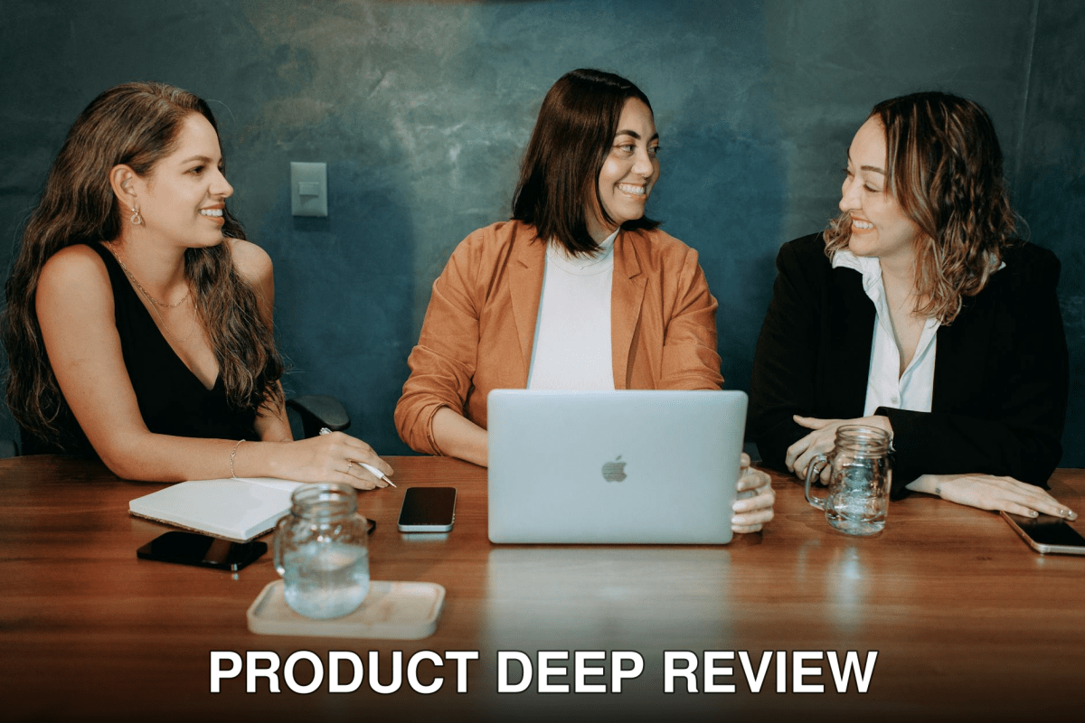 Three women engaged in a professional meeting with a laptop and notes, fostering teamwork and collaboration.