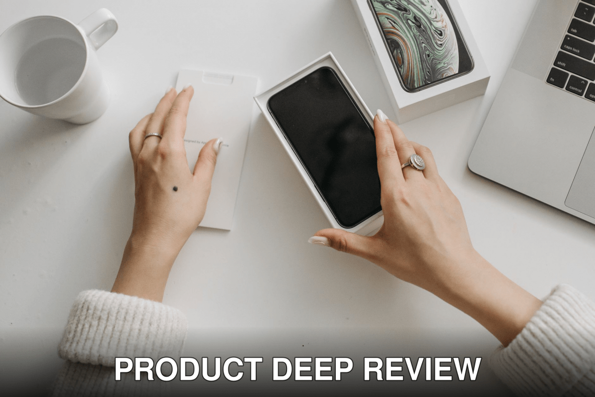 Woman unboxing a smartphone on a white table, showcasing technology and lifestyle