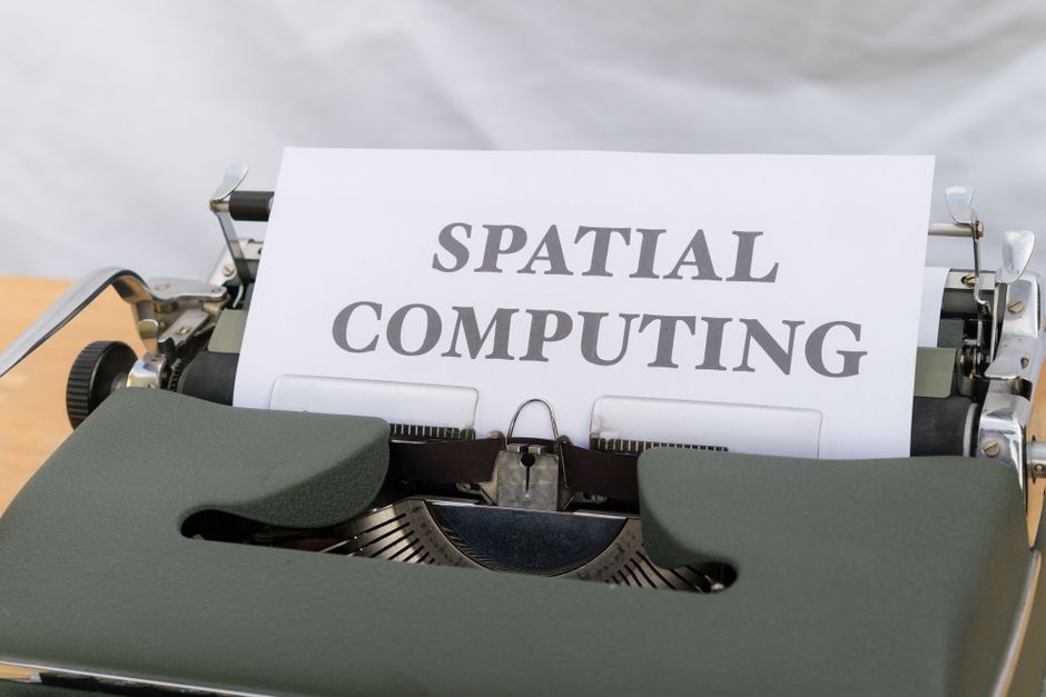 A vintage typewriter with paper reading 'Spatial Computing' suggesting a tech-meets-retro theme.