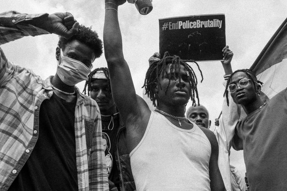 Black and white photo of activists protesting against police brutality.