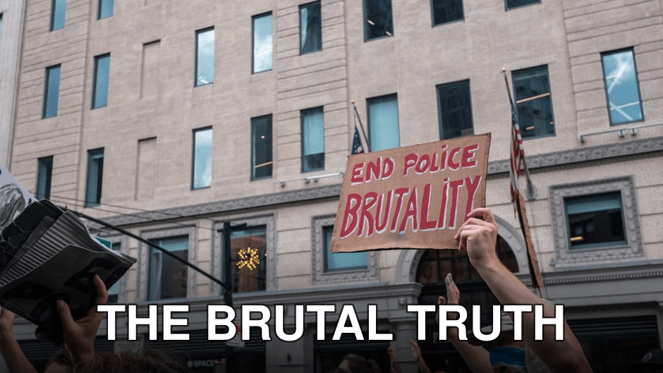 A peaceful protest with participants holding signs against police brutality in a city location.