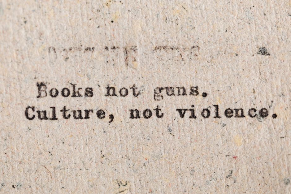 A vintage typewritten quote promoting culture over violence on aged paper.