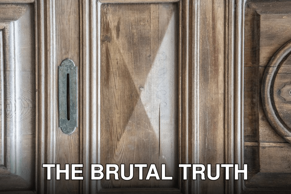 Detailed view of a vintage wooden door with intricate patterns and rustic textures.