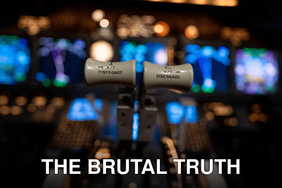 Close-up of airplane cockpit controls with illuminated electronic display panels.