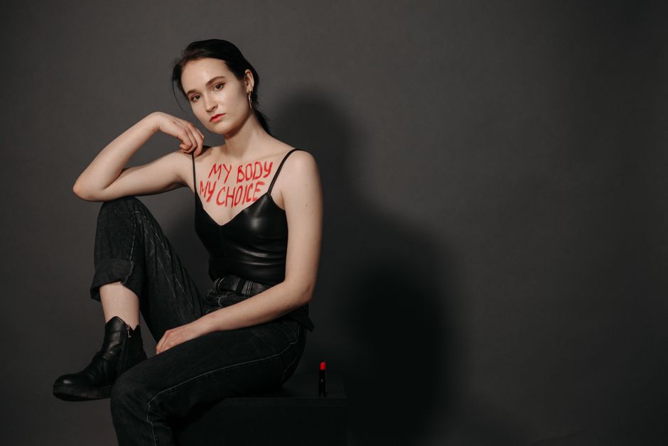 Striking feminist portrait featuring a woman with 'My Body My Choice' message on chest.