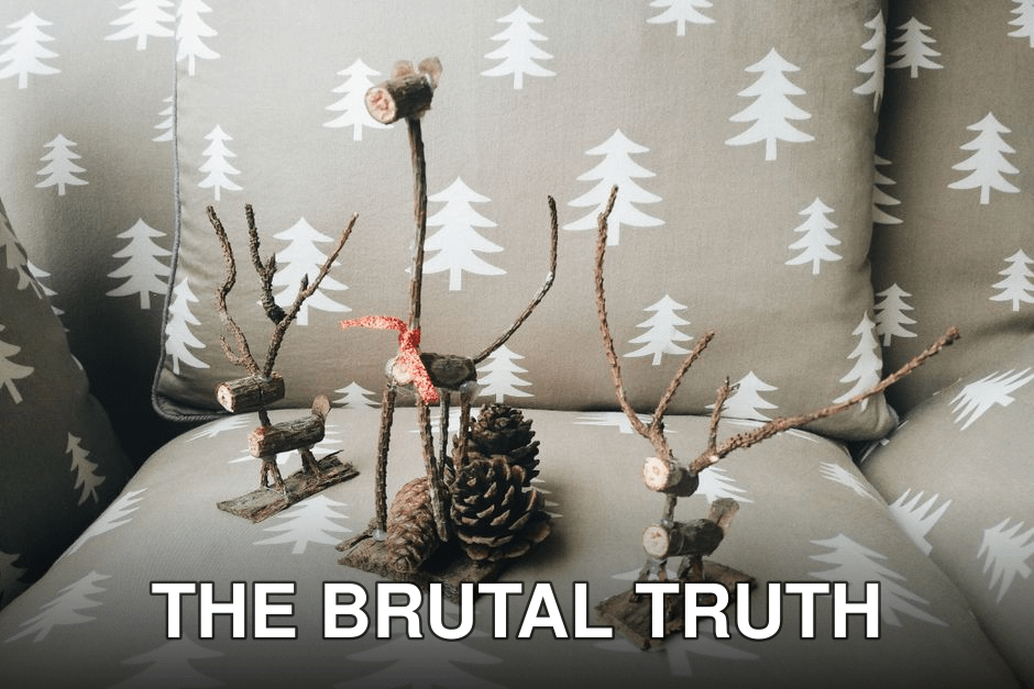 Handcrafted twig reindeer and pine cone arrangement on a festive armchair with tree pattern upholstery.