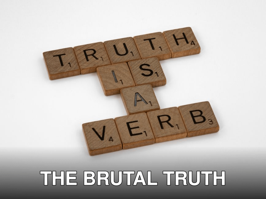 Scrabble tiles arranged on a white background spelling 'Truth is a Verb' for creative representation.