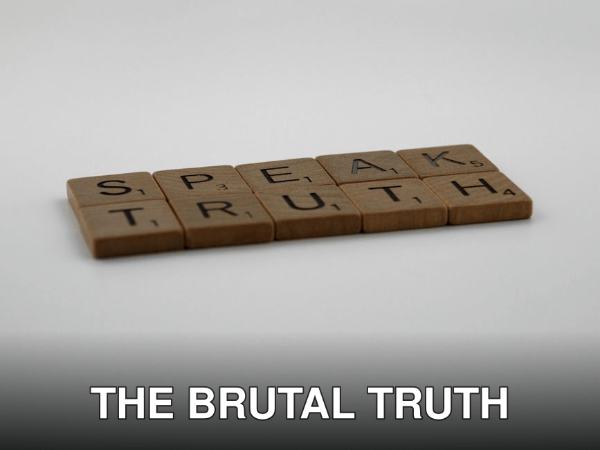 Wooden Scrabble tiles forming the phrase 'Speak Truth' on a white surface.