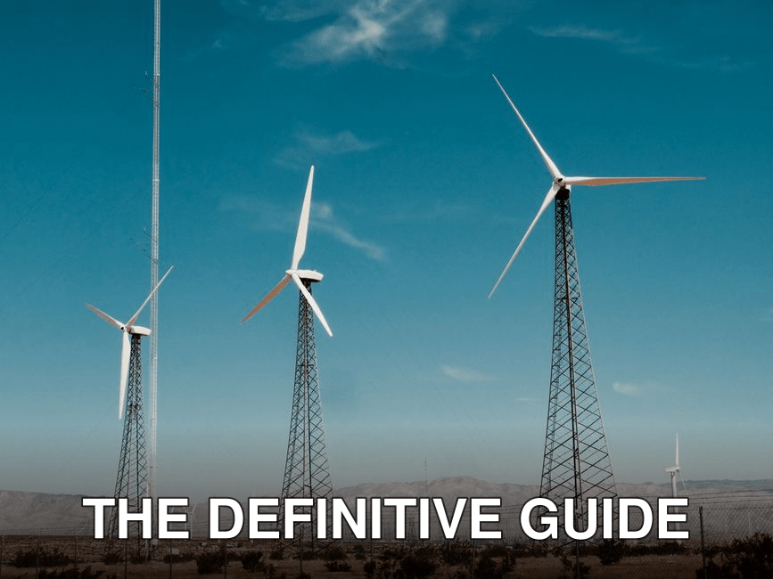 A wind farm with turbines against a clear blue sky in a desert setting.