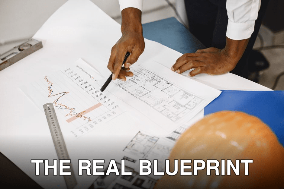 Hands of an architect analyzing blueprints and financial graphs at a desk.