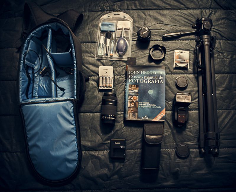 A flat lay of essential camera equipment and accessories for photography.