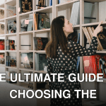 Back view of young female standing near bookcase and selecting literature for leisure