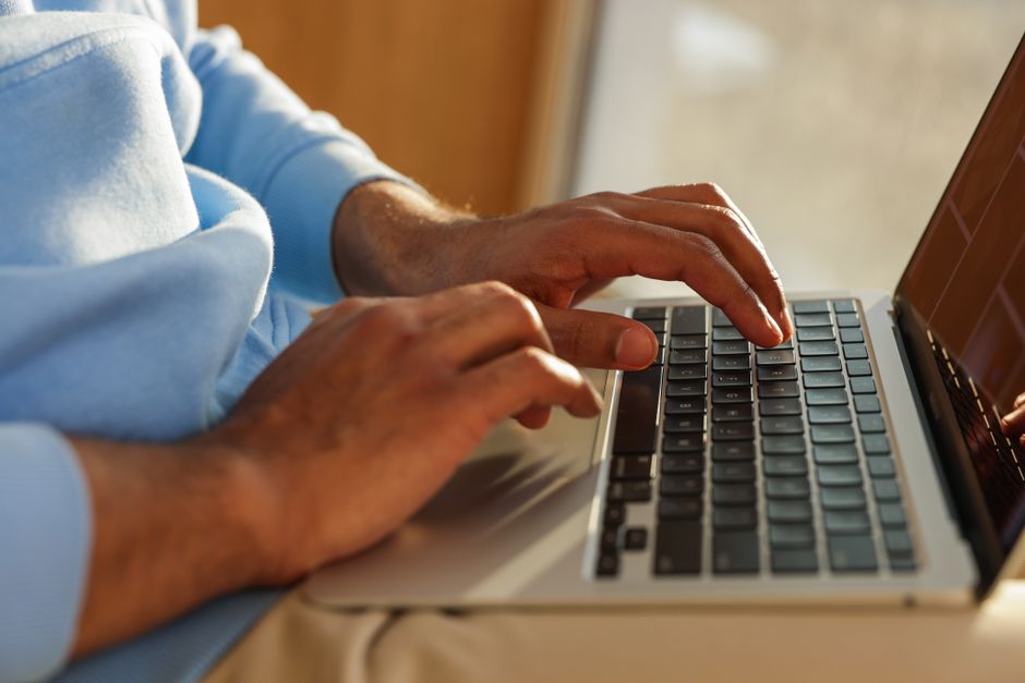 Focused image of hands typing on a laptop, ideal for business and tech themes.