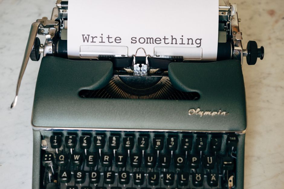 Classic typewriter displaying 'Write something' on paper. Perfect for creative inspiration.