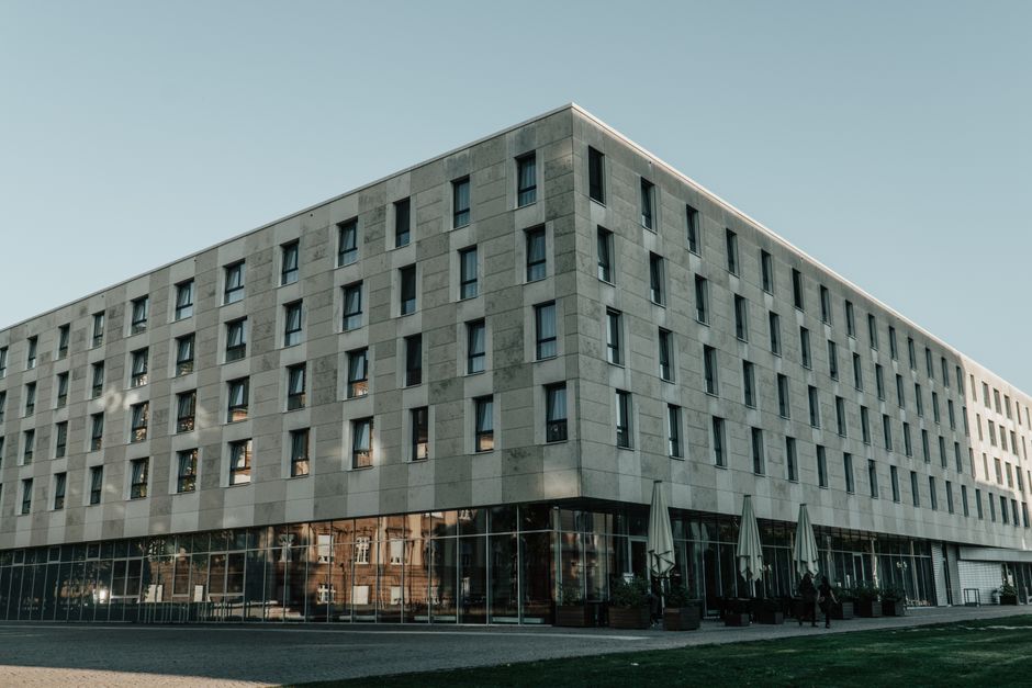 Exterior view of a modern hotel building with glass facades in Darmstadt, Germany.