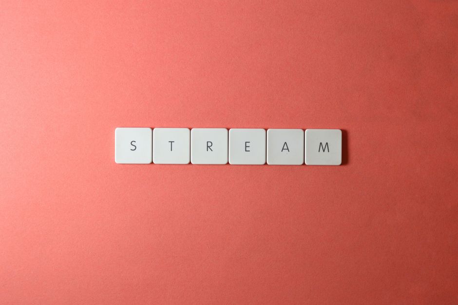 Simple and elegant arrangement of STREAM spelled with keyboard keys on a red backdrop, perfect for creative projects.