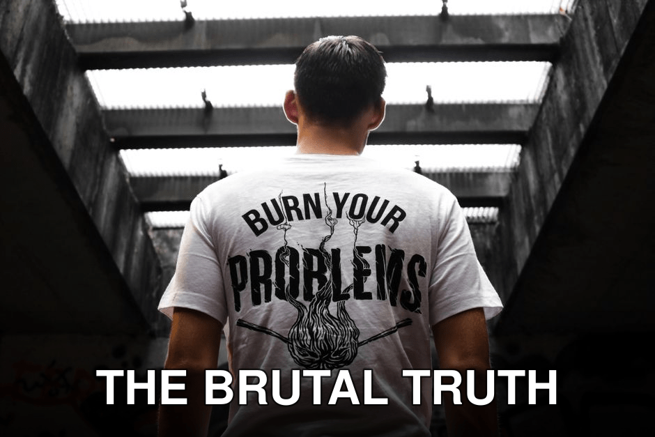 Man standing indoors, wearing a t-shirt with 'Burn Your Problems' text, viewed from behind.