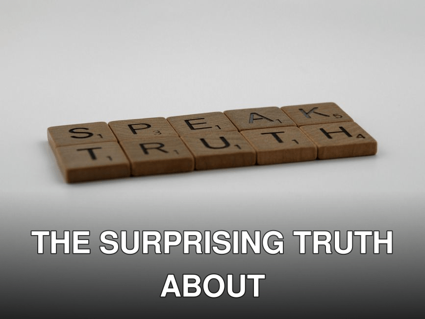 Wooden Scrabble tiles forming the phrase 'Speak Truth' on a white surface.